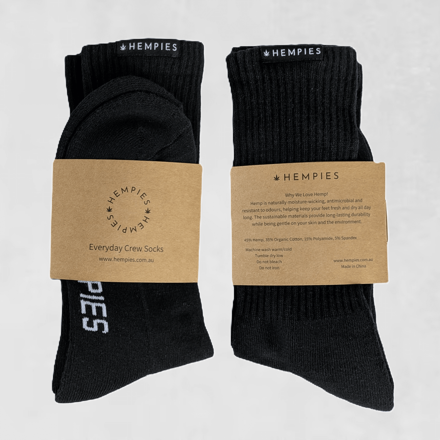 A pair of black hemp and organic cotton blend crew socks with the brand name 'Hempies' displayed on the packaging.